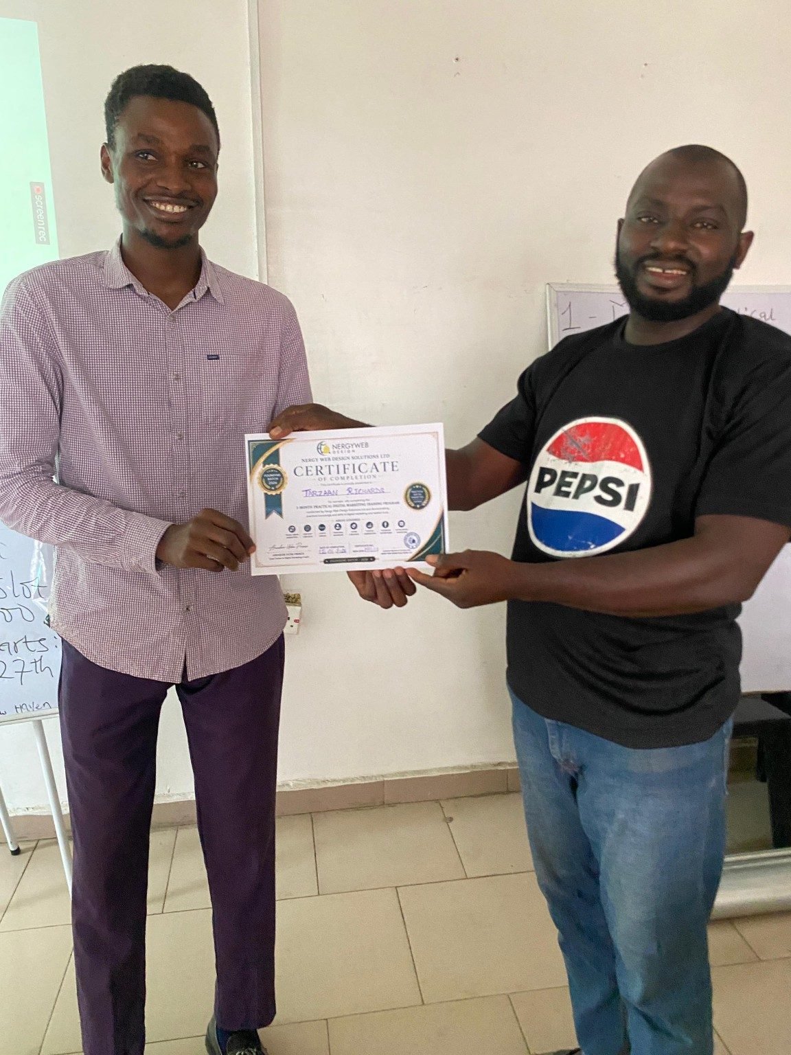 A Batch A student receiving her training completion certificate