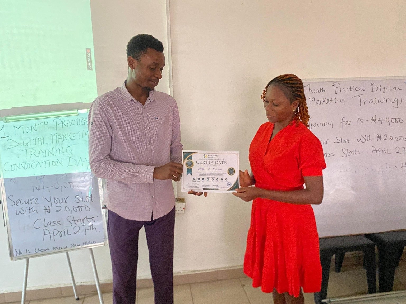 Coach Prince presenting a completion certificate to a Batch A student